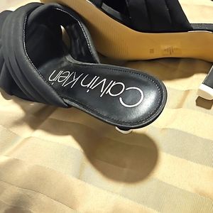 Calvin Klein  heels. Black with square toes criss-cross front with heels out.